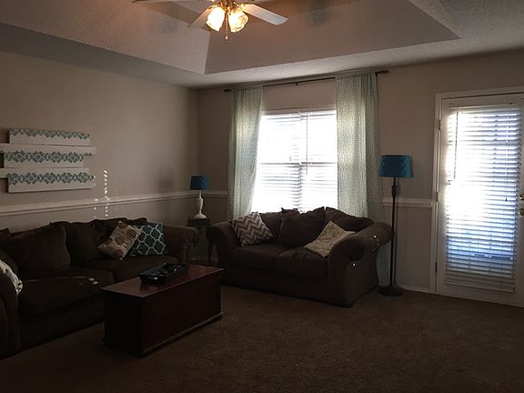 Trayed ceilings with a fan in the living room.