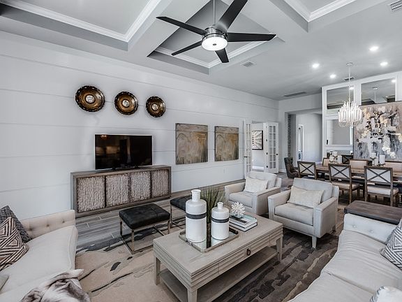 Model Representation Gathering room with coffered ceiling sliding glass doors to the lanai