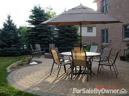 full view of custom patio
						:
						fire pit, spruce trees and landscaping