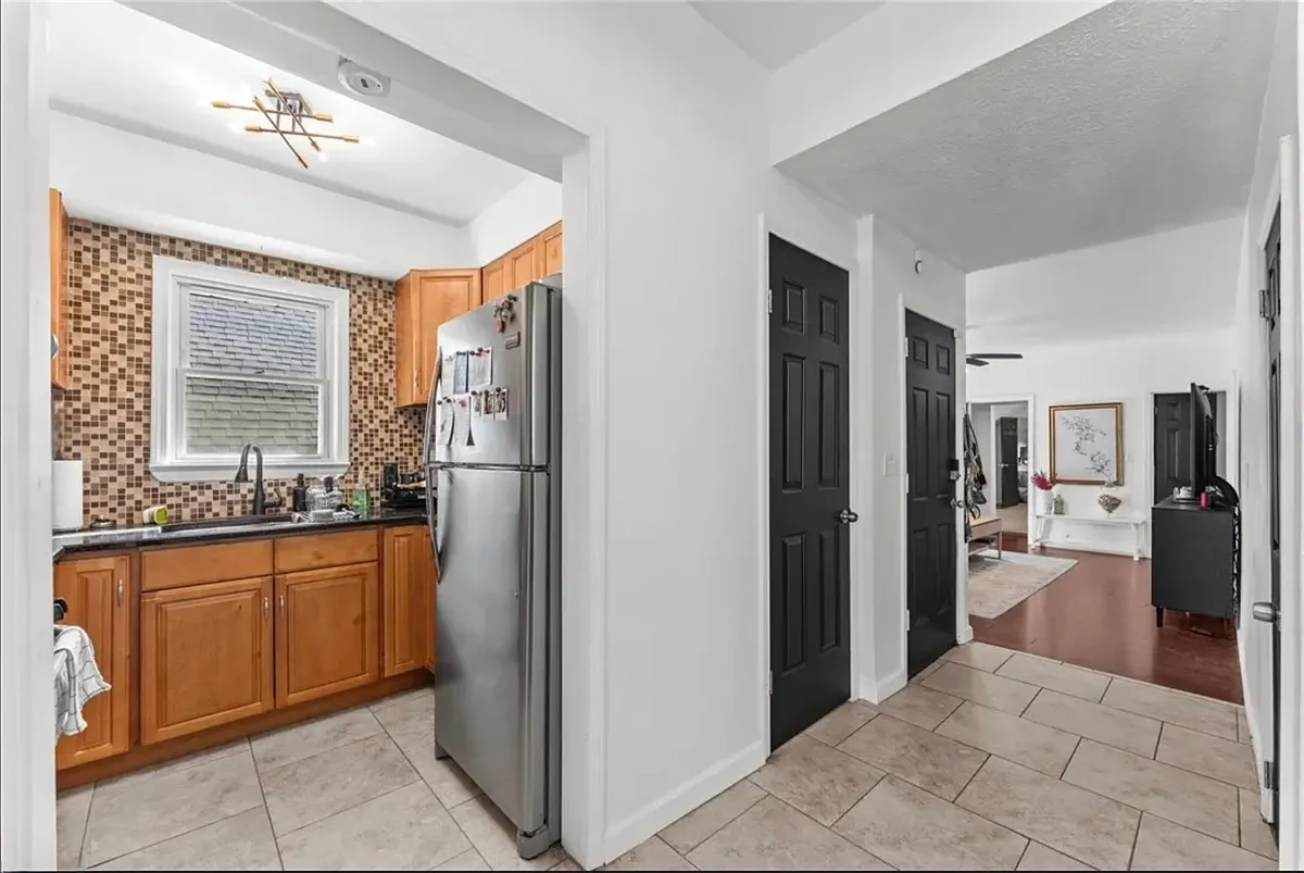 Door on left goes up to the 3rd floor loft; Door on the right is the unit's front door. - 3915 John Ave #1