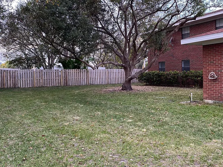 Common backyard area, includes table/chairs and a patio for grilling