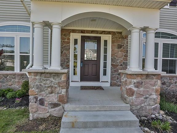 Front Elevation.  Mature perennial gardens.