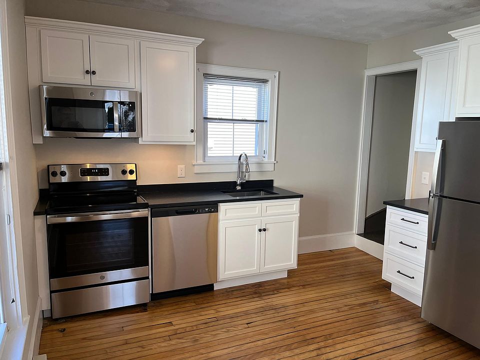 Recently renovated kitchen with white cabinets and granite countertops