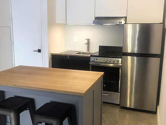 kitchen with laundry closet to the left. bar can be moved to desired position