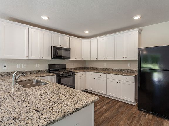 Stunning kitchen with granite counters and recessed lighting