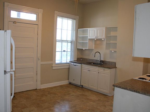 kitchen with granite counters and under counter lights