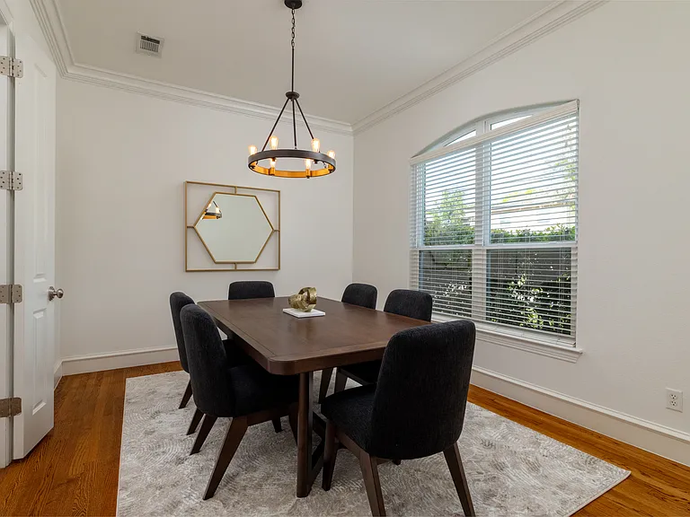 Elegant formal dining room with a striking modern chandelier.