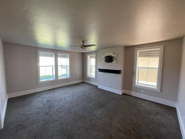 Large front room with shades, built in TV mount, ready for connecting all your devices.