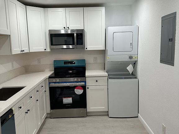 Stackable washer/dryer in unit.