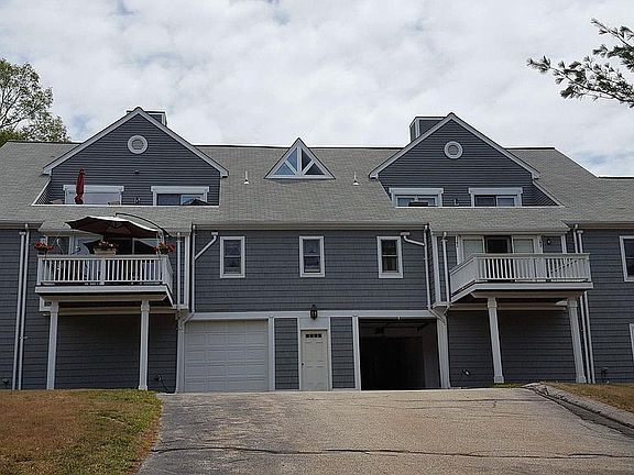 Garage entrance, #46 is balcony to the right. Deck from condo above is over your living room. Master bedroom is window to far right. Nothing above that. Kitchen window is above opened garage door. Window on bottom right is a common storage area. Bec
