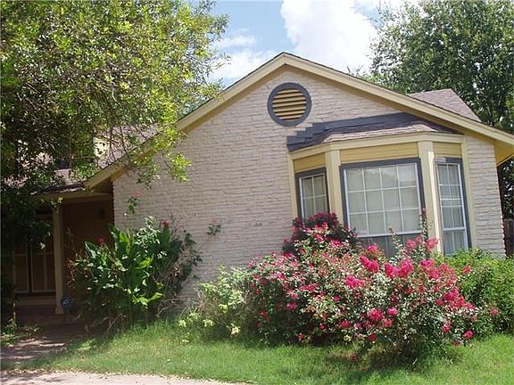 Roses in front of secondary bedroom with bay windows.