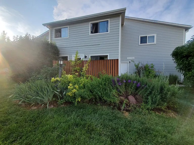 Looking at our home gardens, door into our garage, 2 BR 2nd floor mtn view