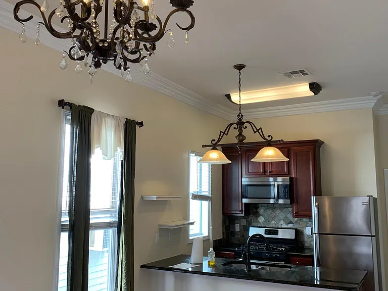 Upgraded kitchen appliances include stainless steel refrigerator, freezer, dishwasher, microwave vent, range combination of stove and oven and under counter mount double sink; apartment now painted light grey