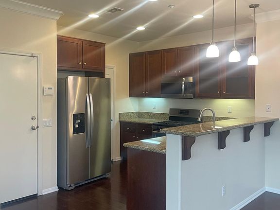 Upgraded kitchen with refrigerator, gas stove, built-in microwave and dishwasher.