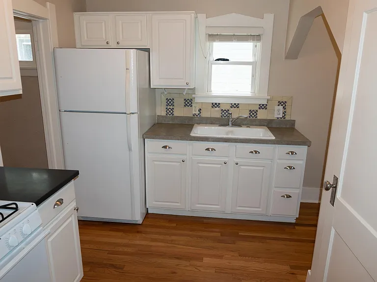 Kitchen view from the doorway of the back bedroom.