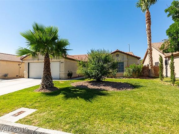 Exterior Front with green grass, palms and additional NEW plantings!