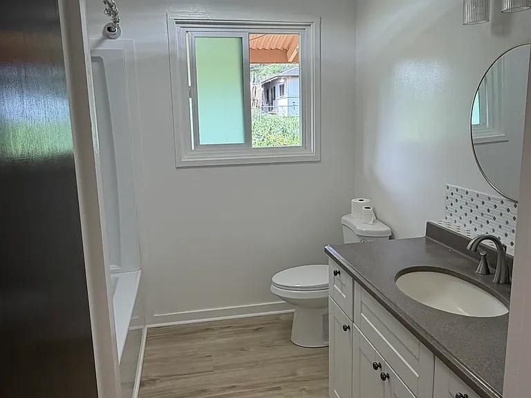 Bathroom with new shower/tub and cabinets