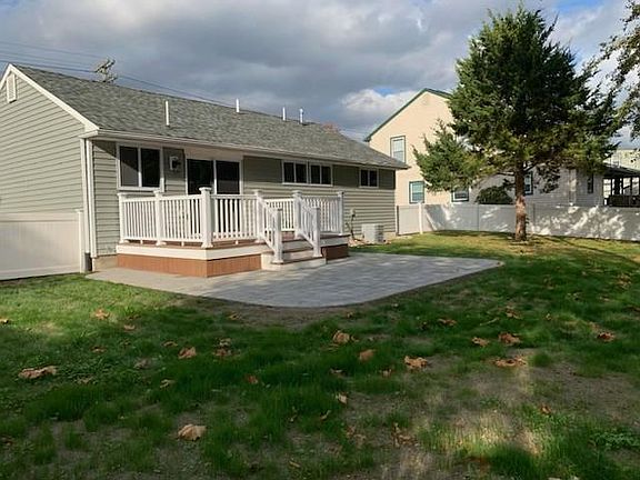 Beautiful composite deck leads to paver patio and large fenced in back yard.