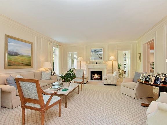 Beyond this light-filled living room is a sun room that overlooks the patio.