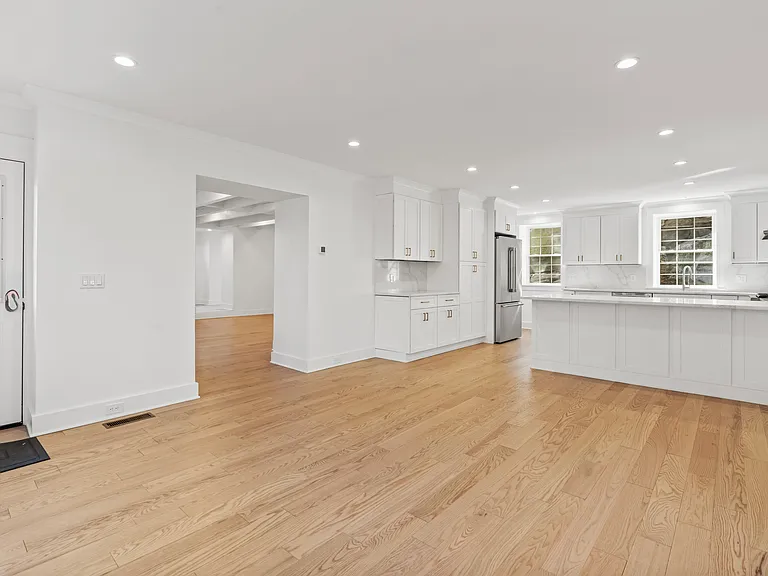 Open dining/kitchen with passageway to living room.