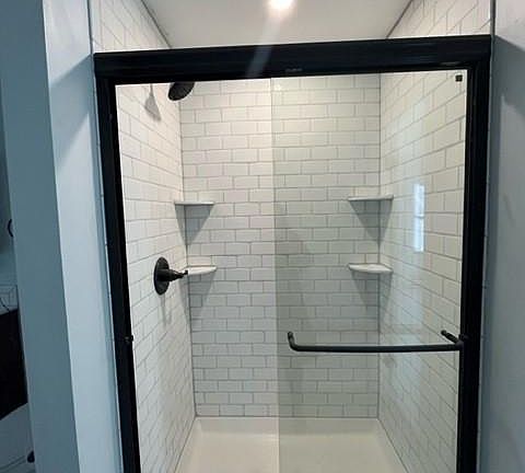 New subway tiled bath with antique bronze fixtures and new sliding glass door (4ft) on the 3rd floor