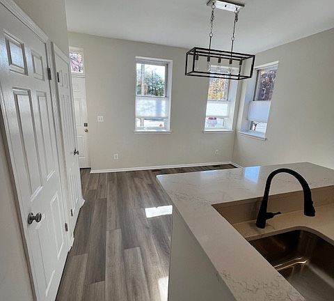 First floor dining room with new flooring and new lighting fixture