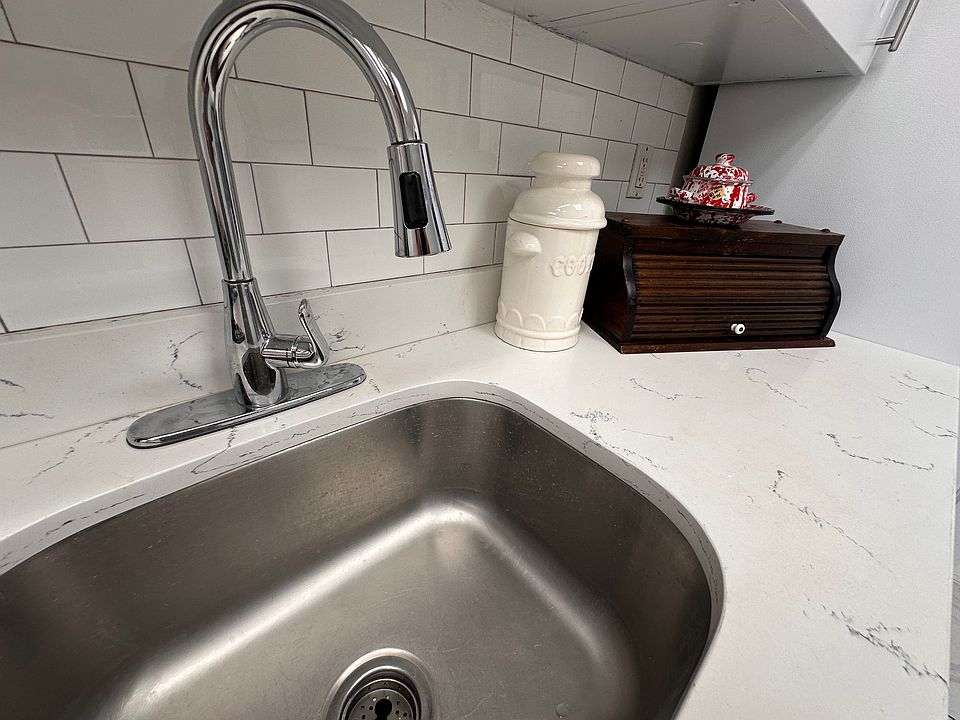 Fresh white kitchen with a brand-new stove and modern appliances.