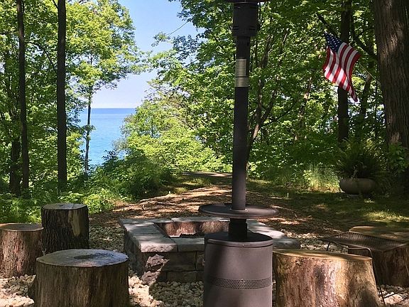 Large rustic outdoor fireplace and steps down to Lake Michigan access and frontage!