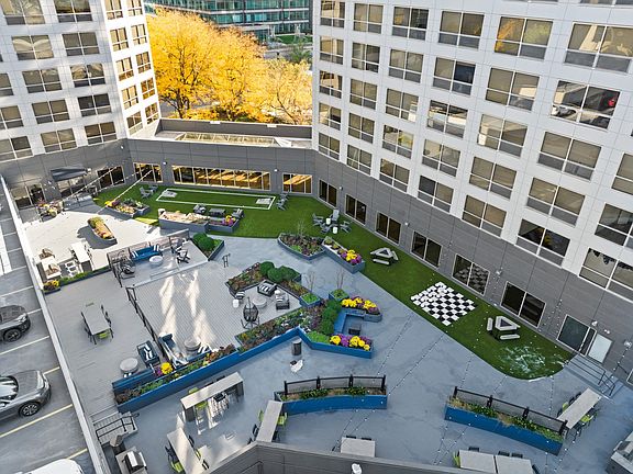 Rooftop lounge with grills, seating, and games at Presidential Towers in Chicago, IL