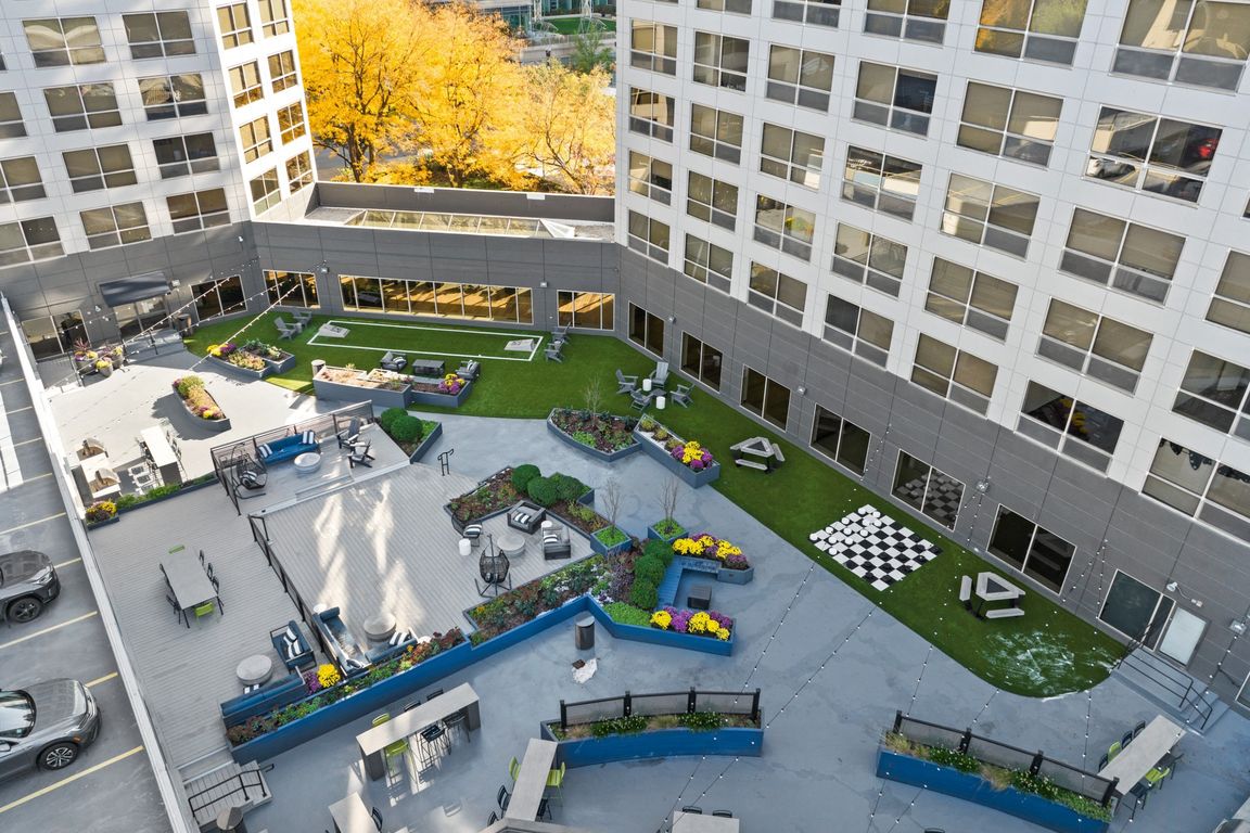 Rooftop lounge with grills, seating, and games at Presidential Towers in Chicago, IL