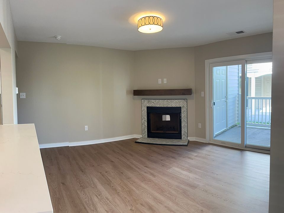 Wood burning fireplace, w/ herringbone marble surround. Sliding glass door to private patio.
