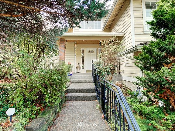Private entry through the lush greenery.
