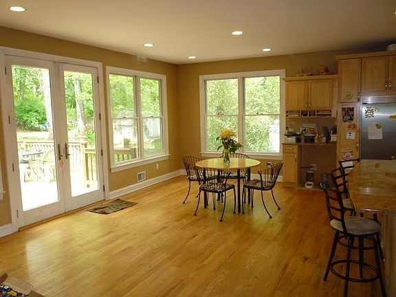 Eating area with sliders to deck overlooking private backyard