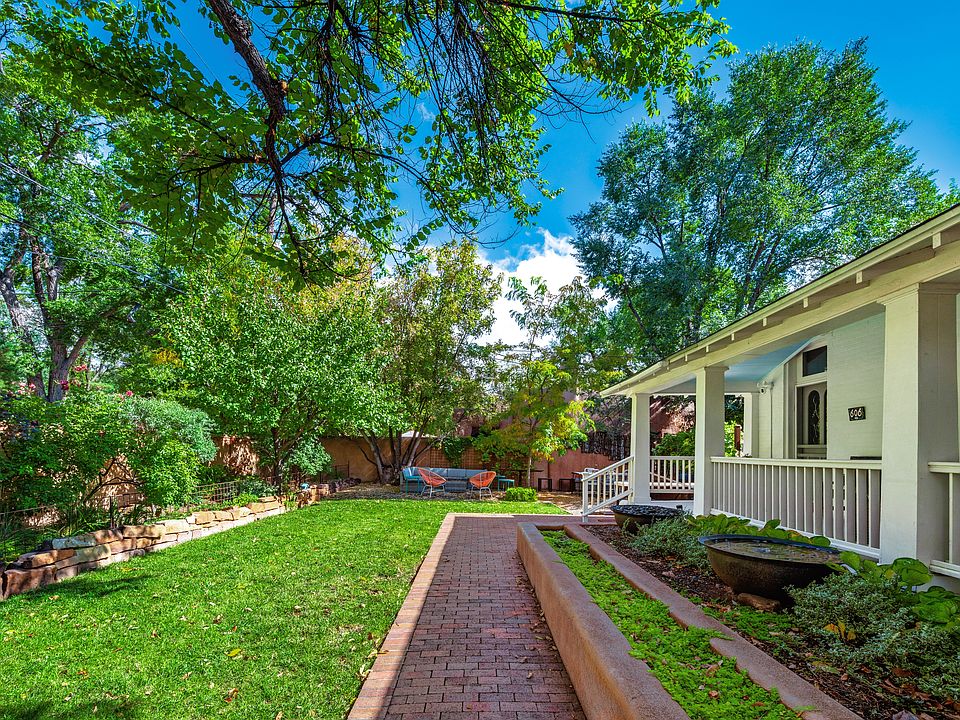 Sugar kettle planters and fountain in front.
