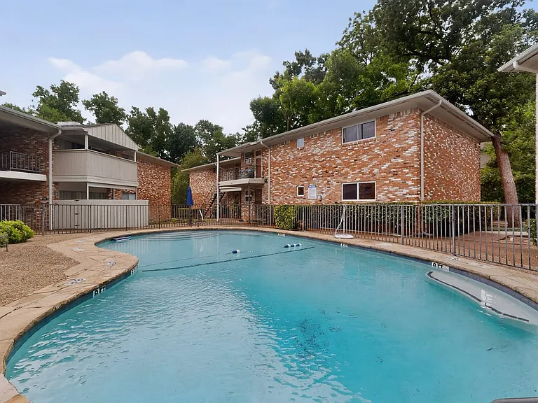 The outdoor swimming pool with a backdrop of trees
