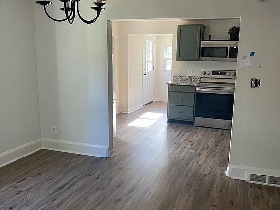 Dining room with view of kitchen and back door (opens to deck)