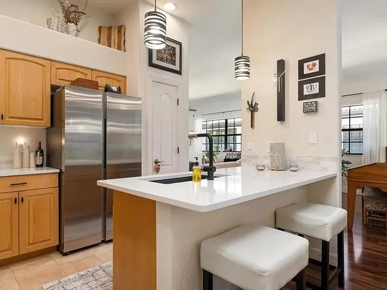 Open and bright kitchen looking to front entrance area and living room