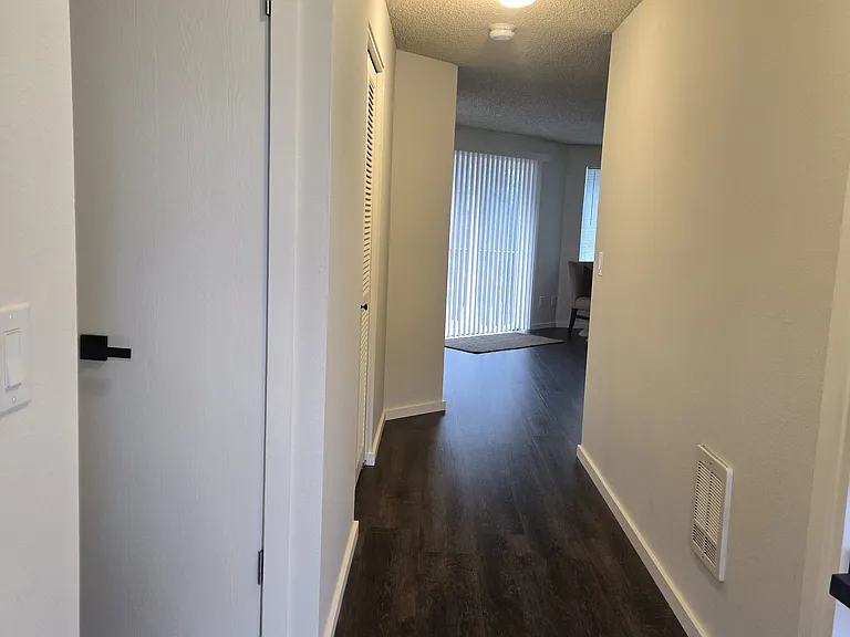 Entry view, towards front room and sliding door to deck. ( rug not included).