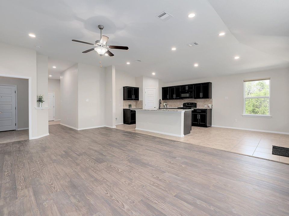 Welcome into a very beautiful home with new paint, gray tone hand scraped vinyl plank flooring, tall ceilings and recessed lighting throughout the home. Notice how you do not walk straight into the living room.