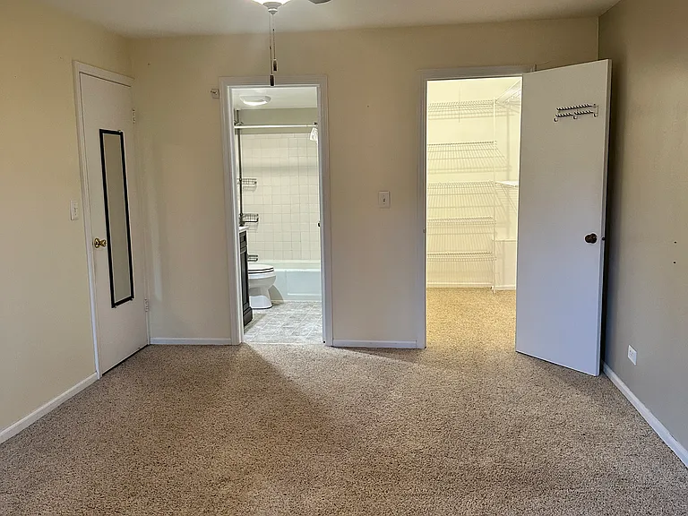 Master bedroom with walk in bathroom and large walk in closet