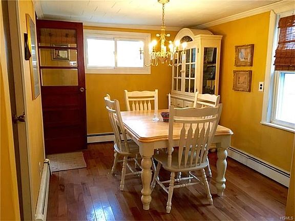 Separate dining room with hickory floors and convenient side door to the screen in porch.