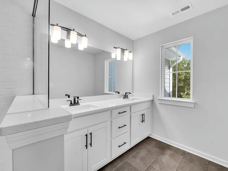 Master en-suite bathroom with 2 sinks, walk in shower and water closet.