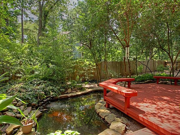 Back deck and koi pond with water fall to the right of deck.