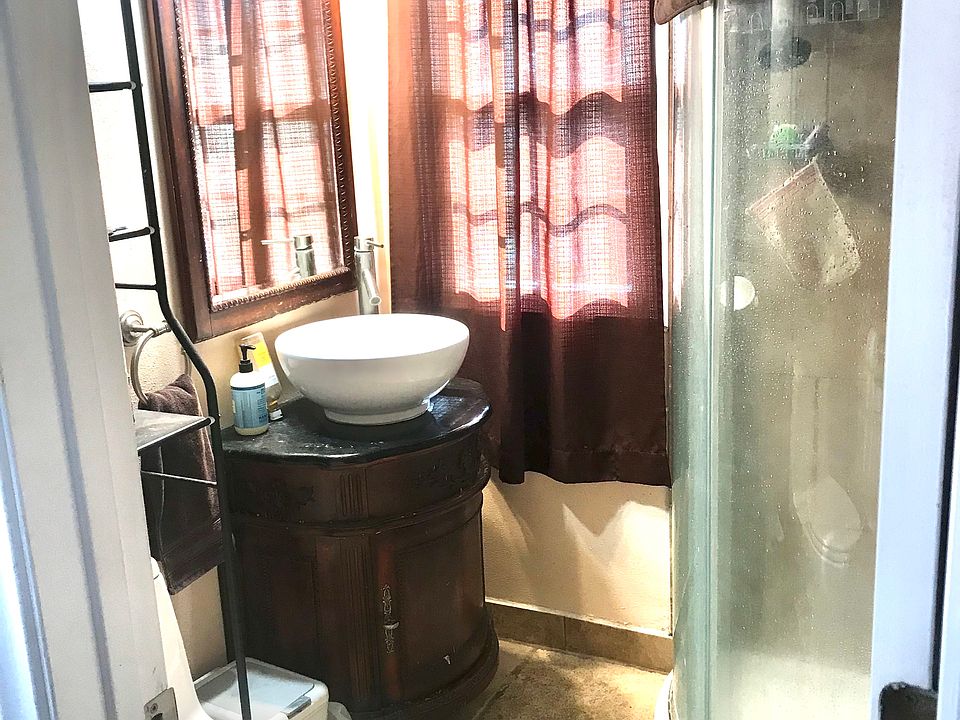 Full bath to the left in a short hallway coming in from the deck.