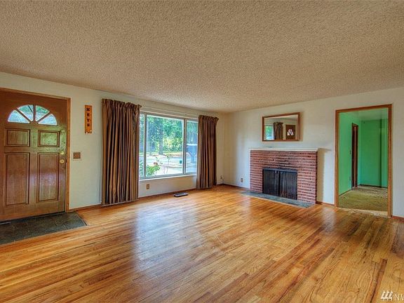 Large open living room with brick fireplace