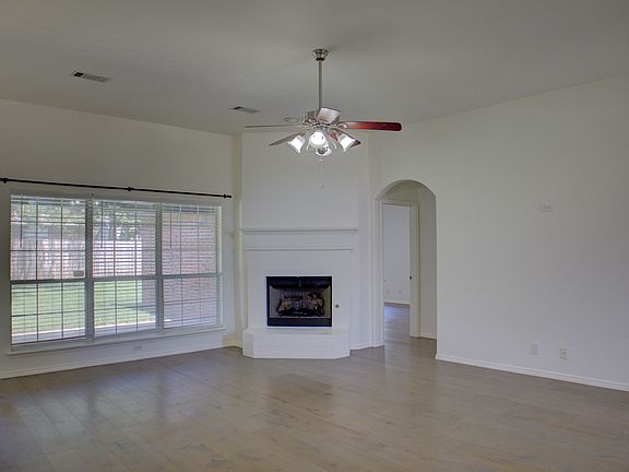 living room w/ wood floors and fireplace