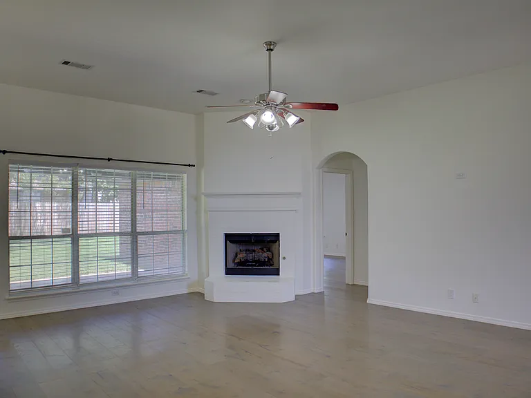 living room w/ wood floors and fireplace