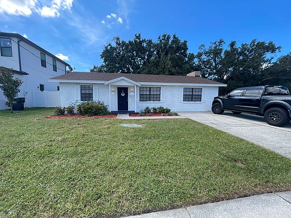 Front view of this three bedroom, two bath home with two fireplaces and ceiling fans, and all the rooms with a fenced in private backyard
