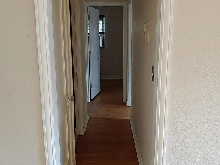 Hall, duh. There is a back door that goes down to laundry and the back courtyard and parking space. Yep, front and back doors! Oh and there is a broom closet. literally.