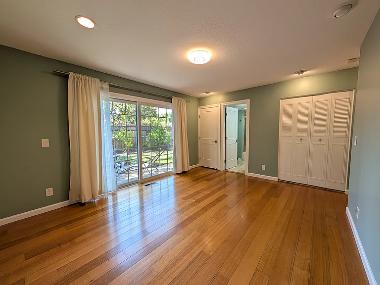 Master bedroom facing back yard towards living room.